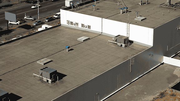 Commercial roofing crew installing TPO membrane on a flat roof in guilderland, NY – commercial roofers near me